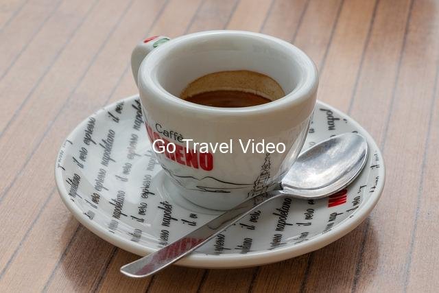 A cup of coffee on a saucer with a spoon Description automatically generated with medium confidence