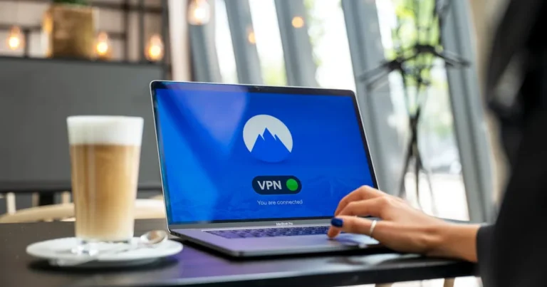 A person using a laptop with a VPN connection in a modern cafe setting, showcasing remote work and i